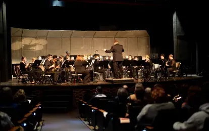 students playing in an orchestra on stage 