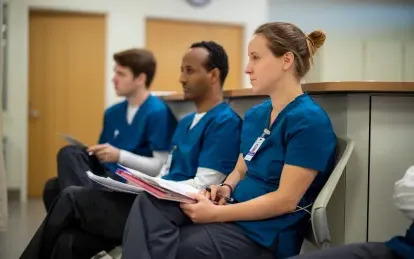 nursing students sitting in a lab looking attentive 